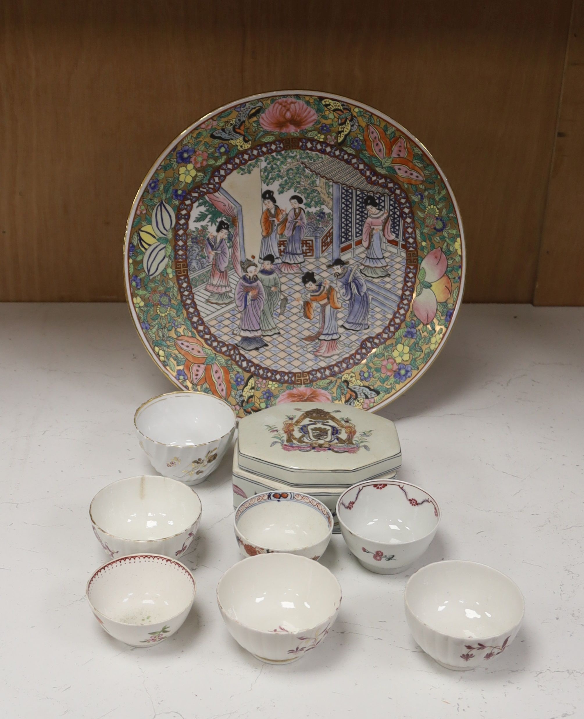 Seven 18th century English porcelain tea bowls, an armorial box and cover and a famille rose dish, diameter 30cm